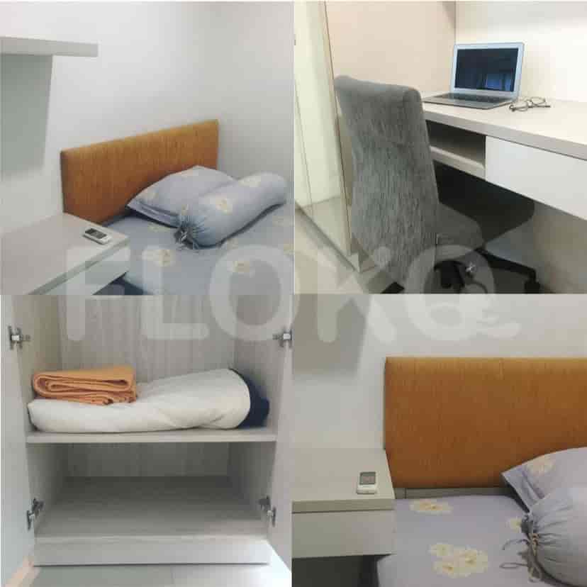 A second bedroom setup with a bed, desk, and wardrobe.