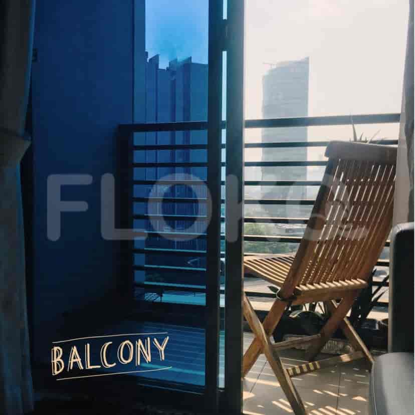 A balcony with outdoor furniture and a view.