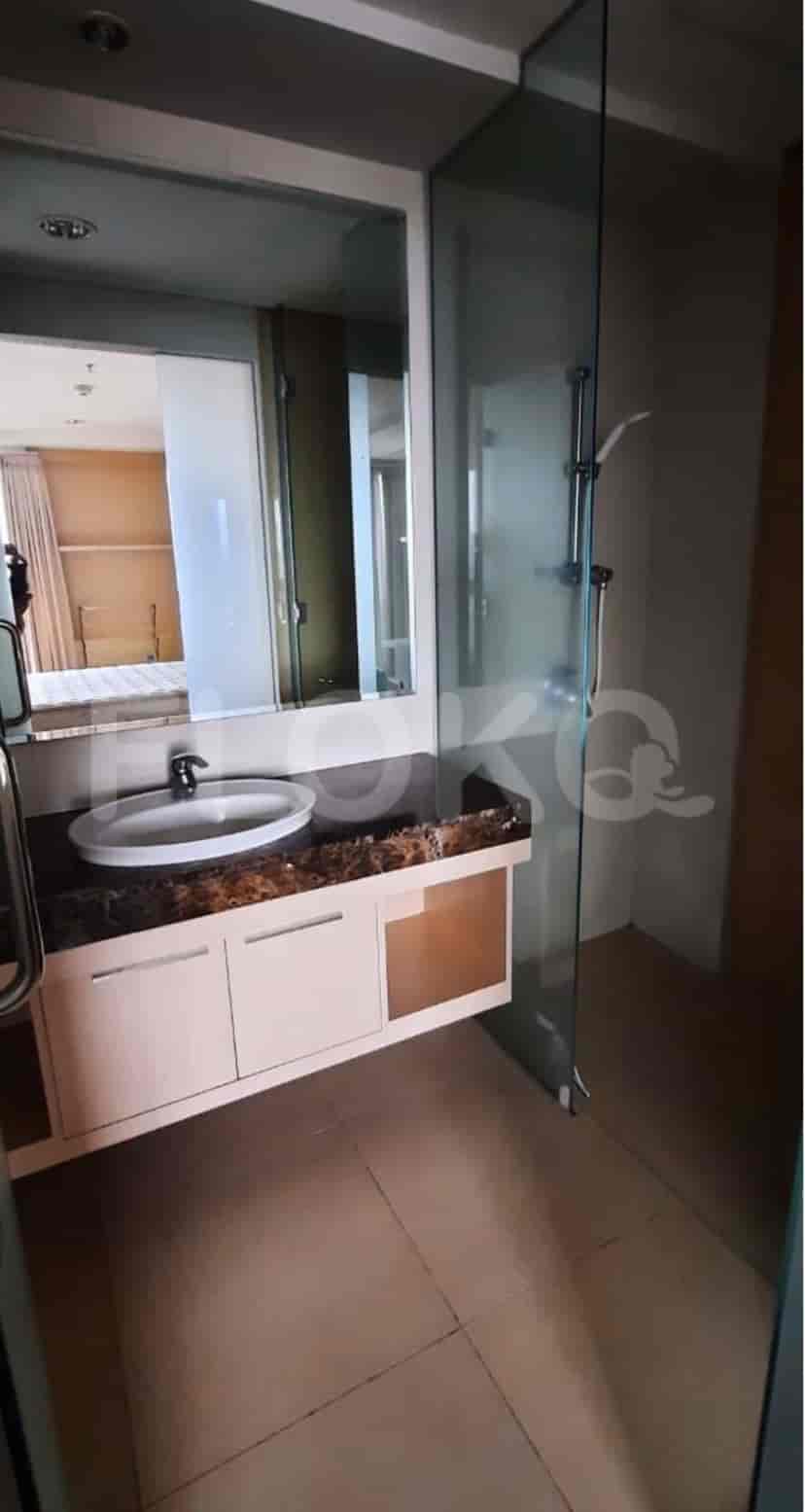 Modern bathroom with a glass-enclosed shower, a vanity, and a large mirror.