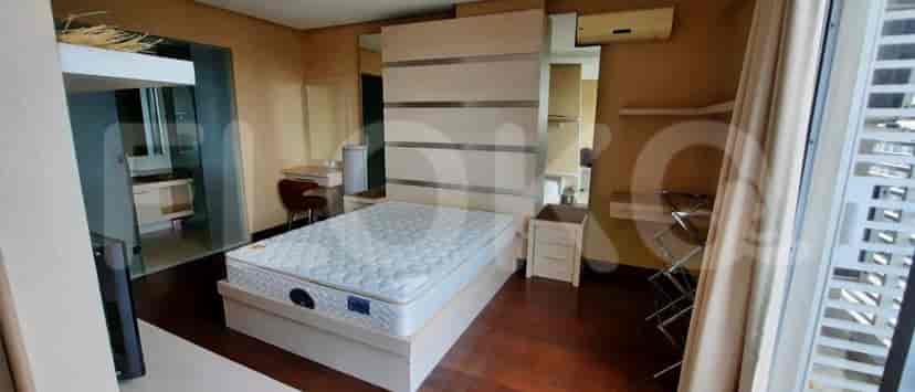 Bedroom with a bed, nightstand, and large mirror.