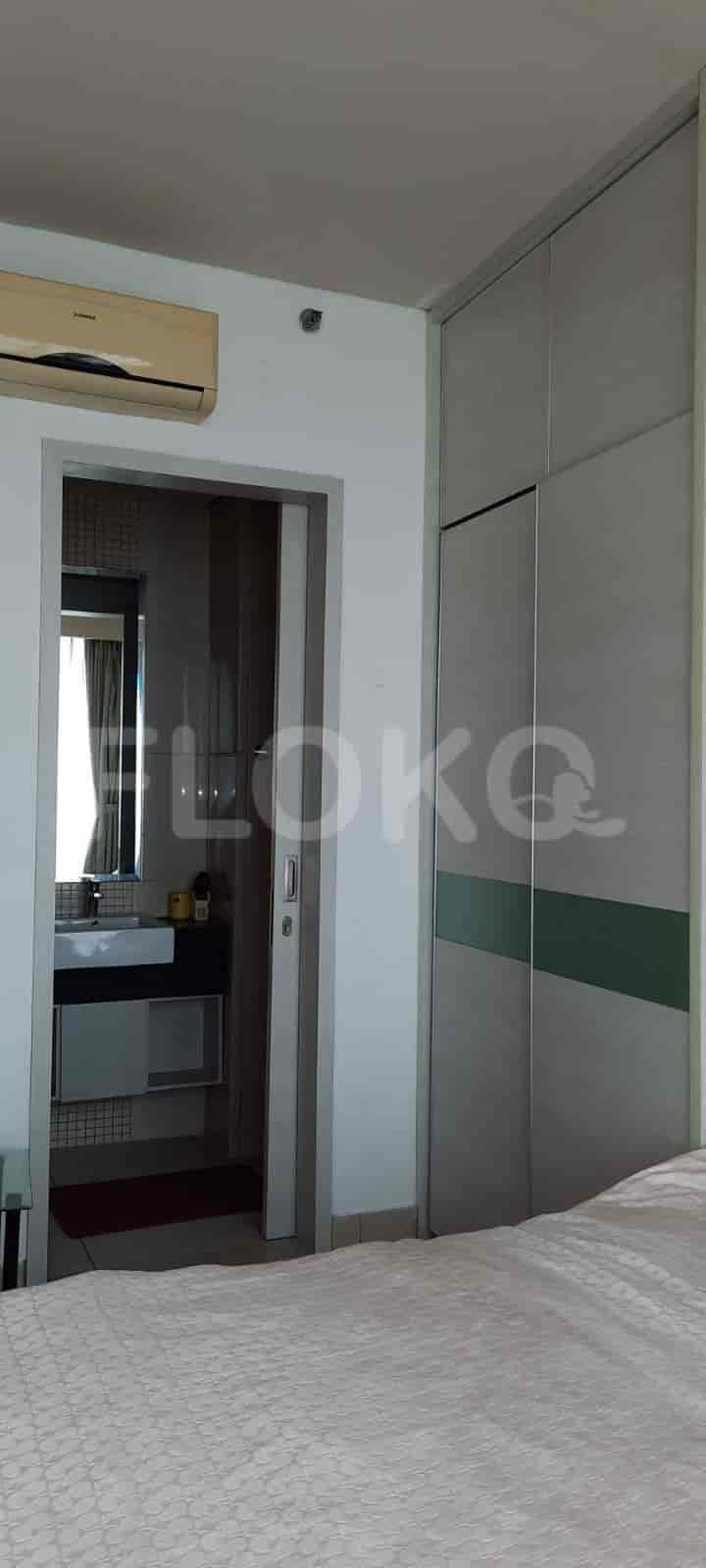 A bedroom with a partially visible bathroom and a large closet.