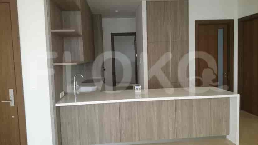 A kitchen with a bar counter and wooden cabinets.