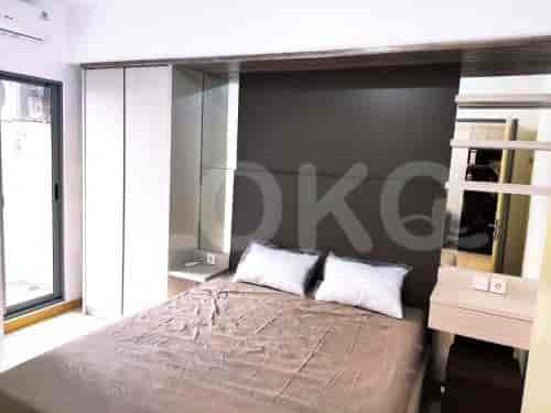 Bedroom featuring a large bed, built-in closet, and side tables.
