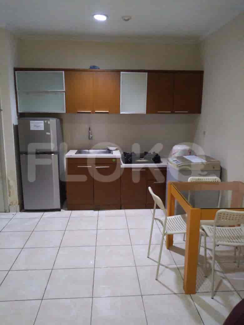A kitchen with cabinets, appliances, and a dining area.