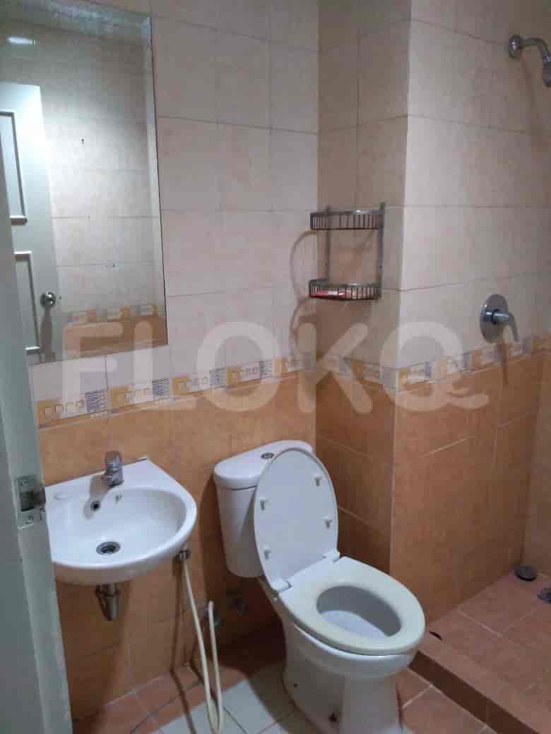 A bathroom with a toilet, sink and shower.