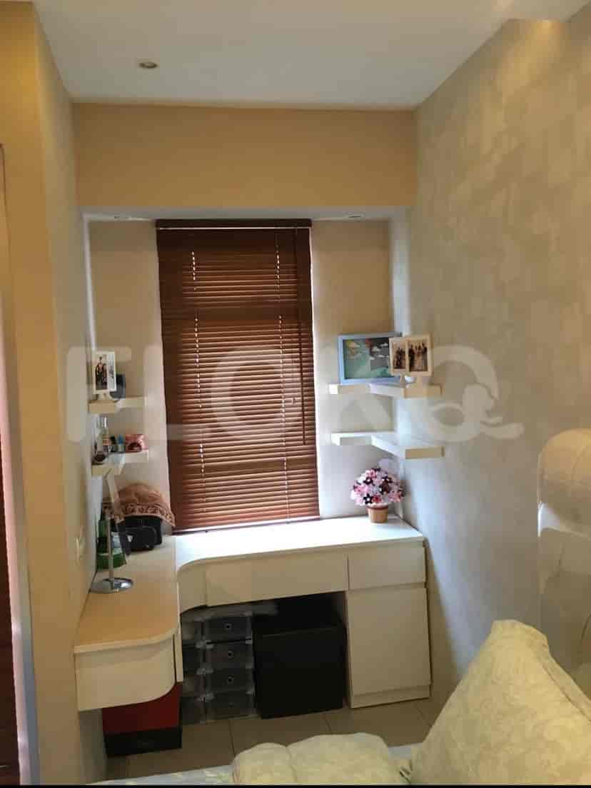 Small bathroom with a shower, curtain, and tiled walls.