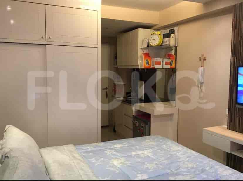 Bedroom with a bed, desk, and storage.