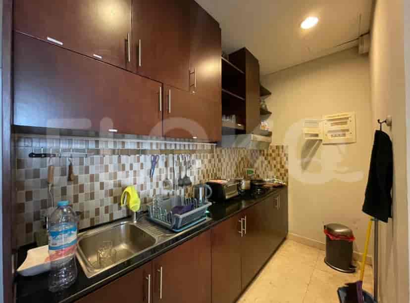 Dark-wood kitchen with stainless steel appliances.