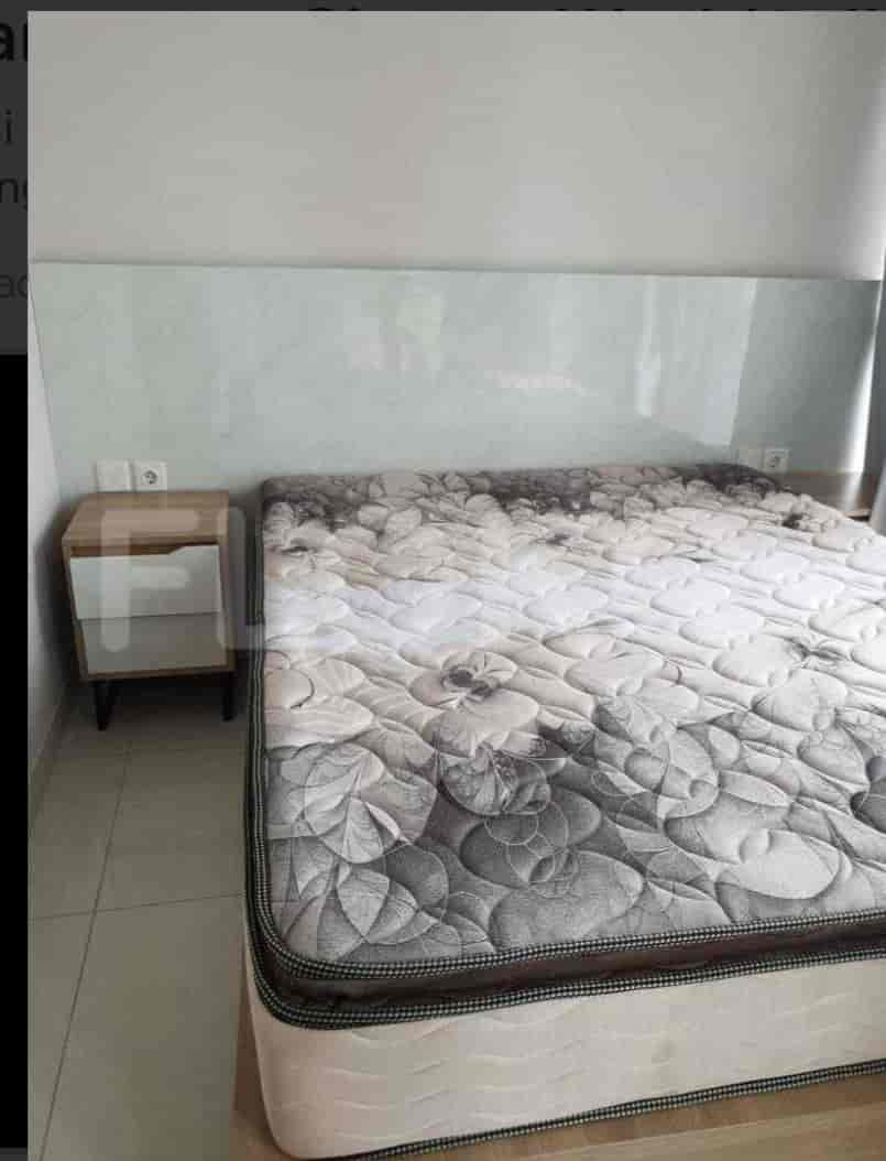 Bedroom with a queen-sized bed and a nightstand.