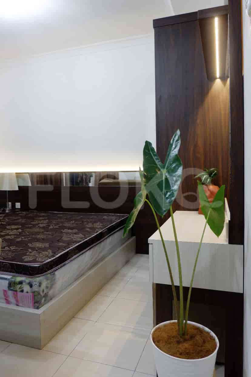 A modern bedroom featuring a bed, wardrobe, and bedside table.
