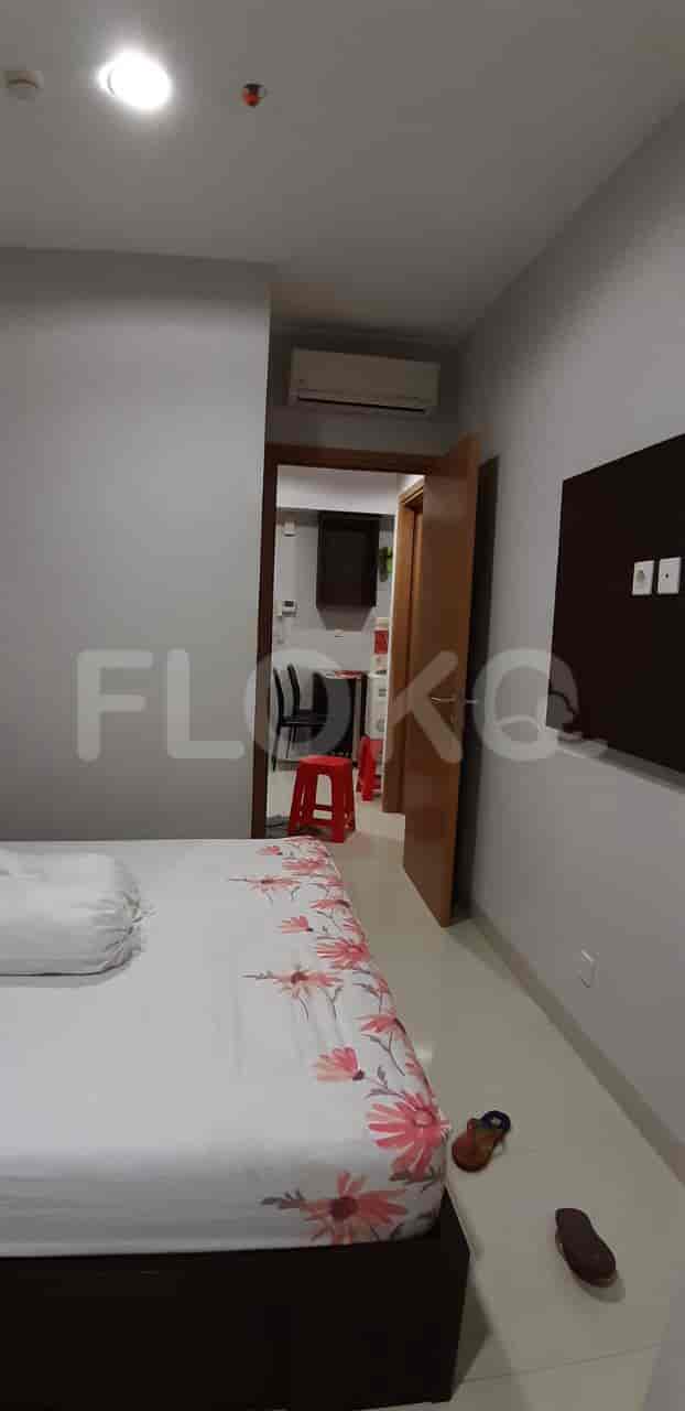 Another view of the bedroom showing the entrance to another room.