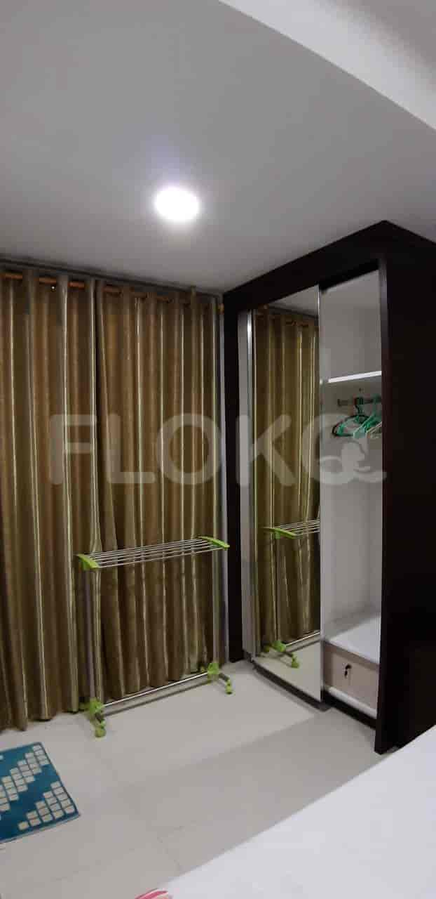 Bedroom with bed, curtains and wardrobe.