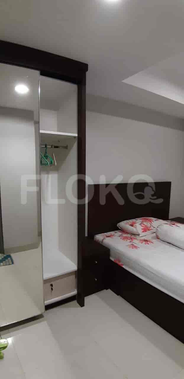 Bedroom with a bed, wardrobe, and mirror.