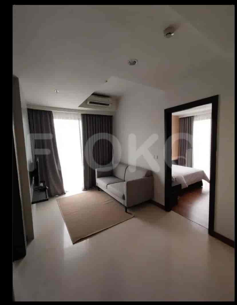 Another view of a modern bedroom with a king-size bed and large windows.