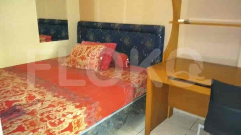 Bedroom with bed, desk, and mirror.
