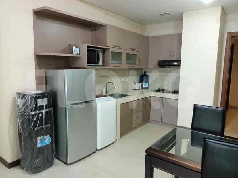 A well-equipped kitchen with wooden cabinets, a refrigerator, and a washing machine.