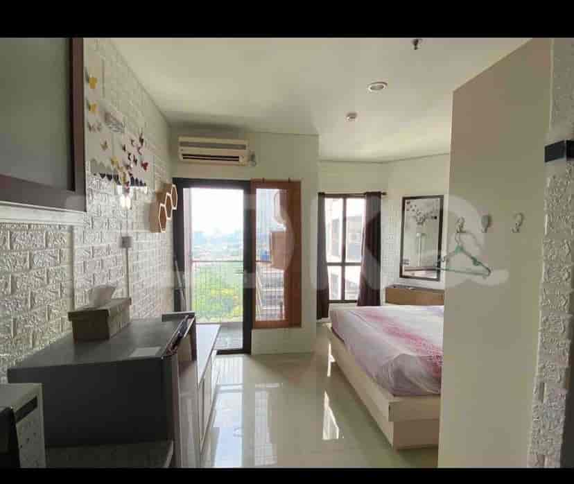 A cozy bedroom with a double bed, large window, and white brick patterned walls.