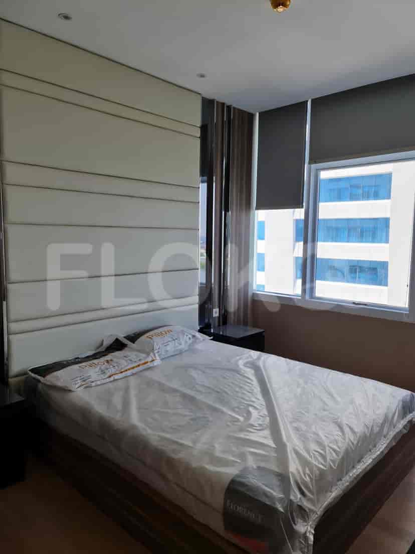 Luxurious master bedroom with a large bed and decorative headboard.