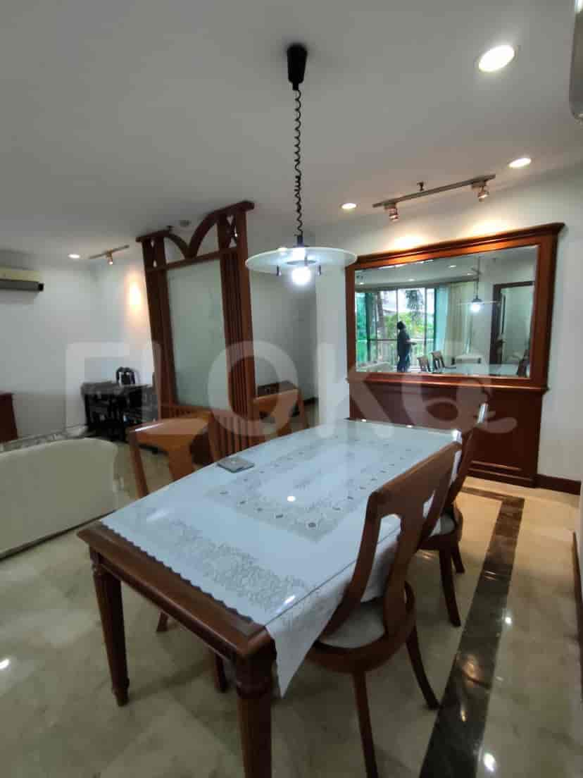 A dining area with a table and chairs.