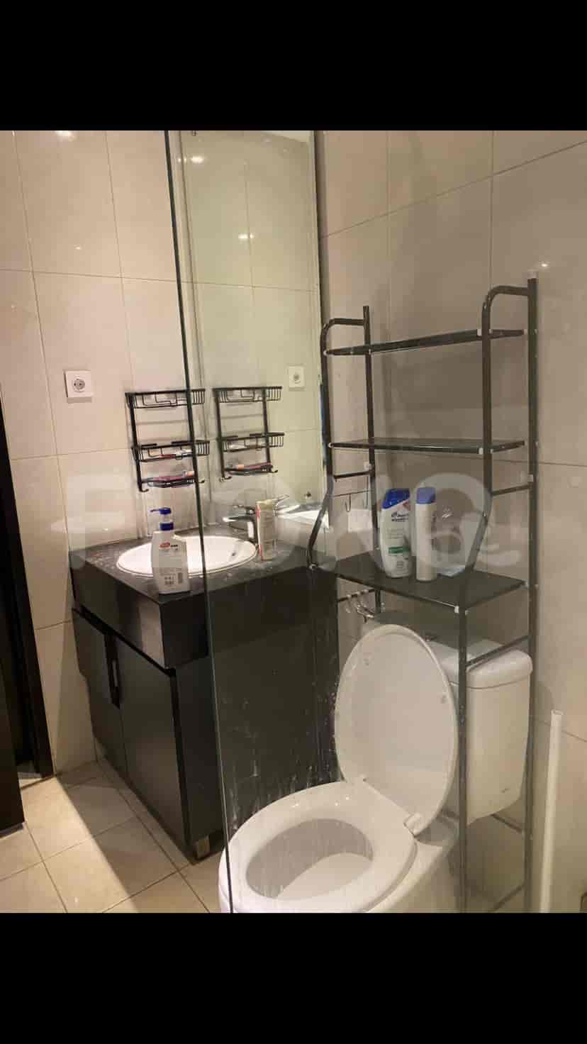 Modern bathroom with a toilet and sink.