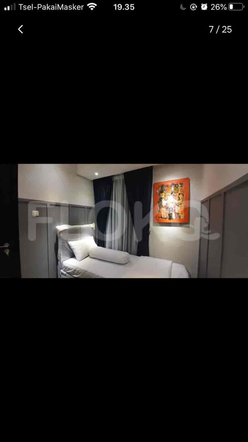 Bedroom with a single bed and artwork.