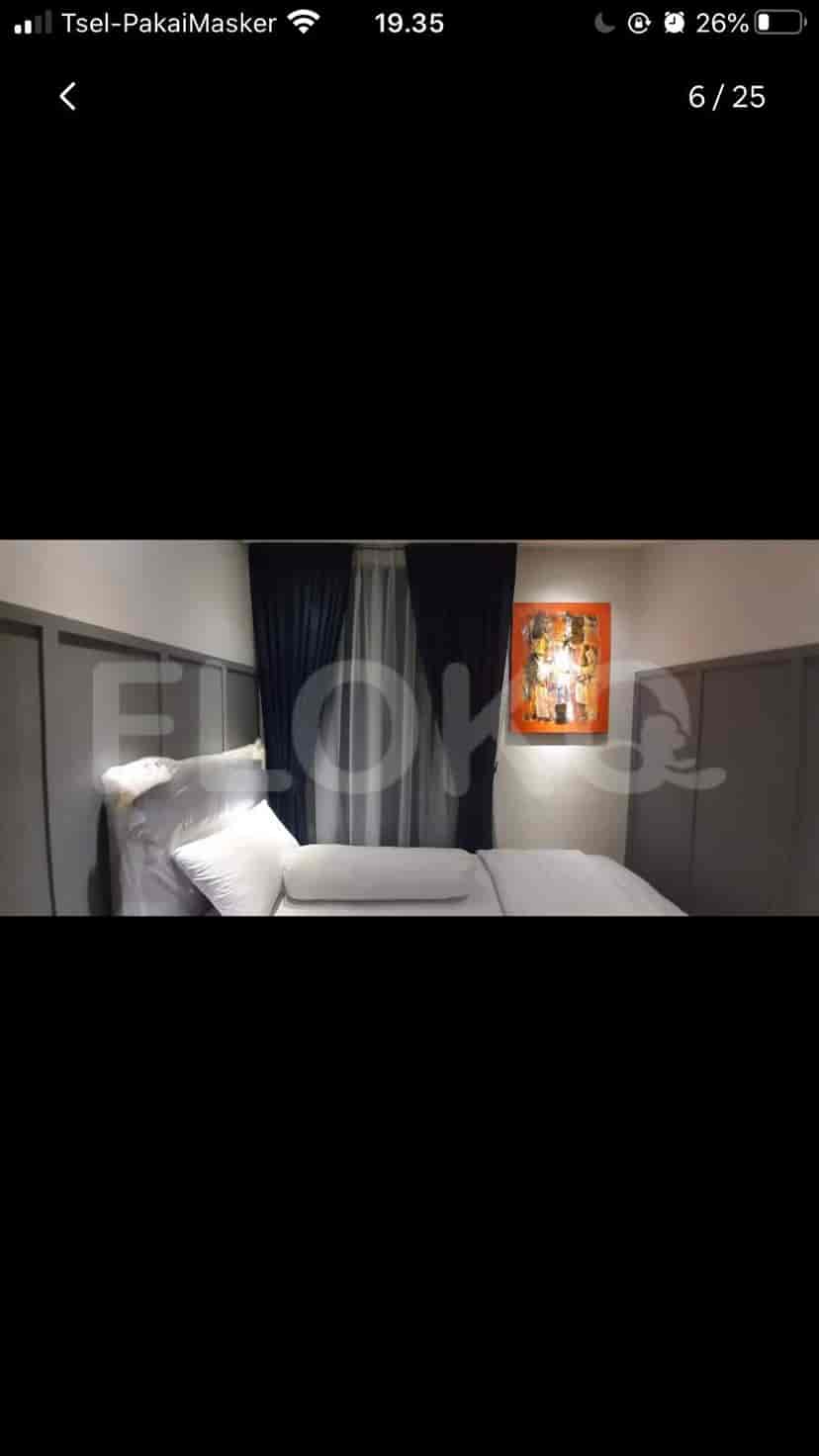 Bedroom with a single bed and artwork.
