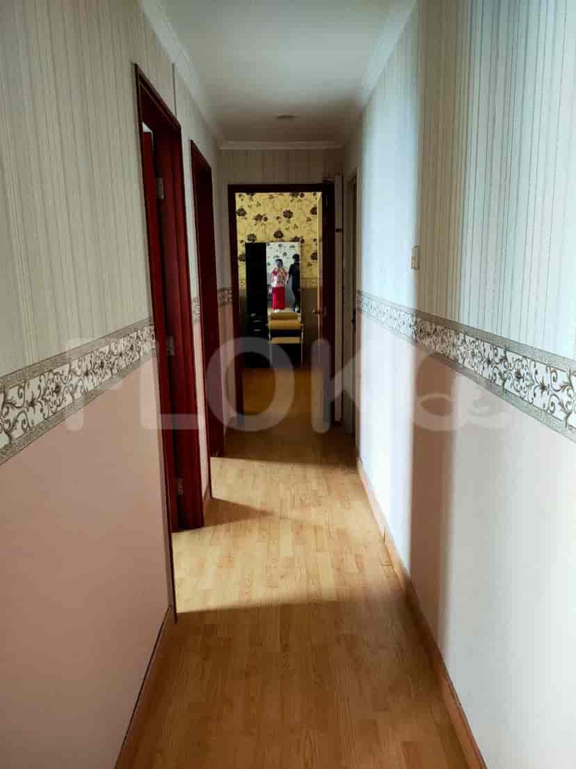 Hallway with closed doors and light-colored walls.
