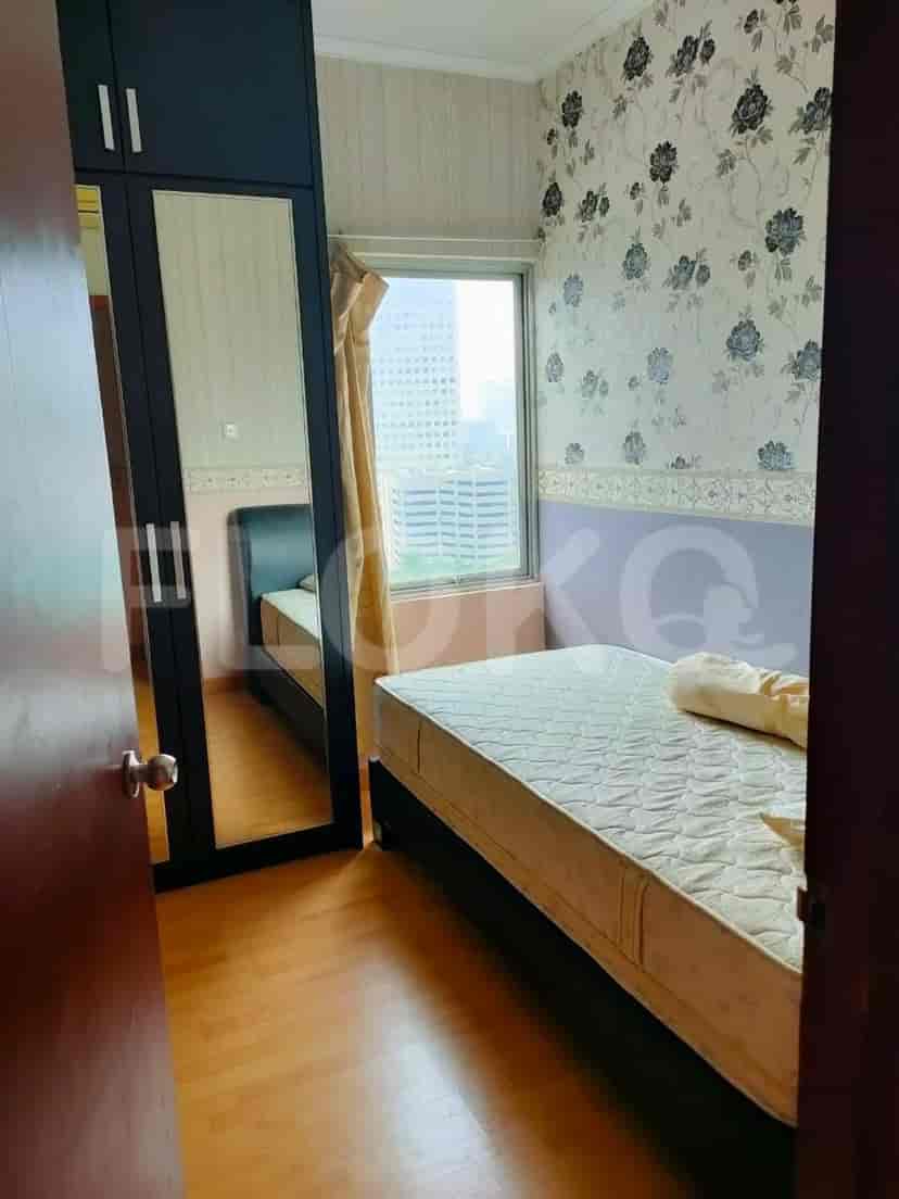 Bedroom with a bed, wardrobe, and window.