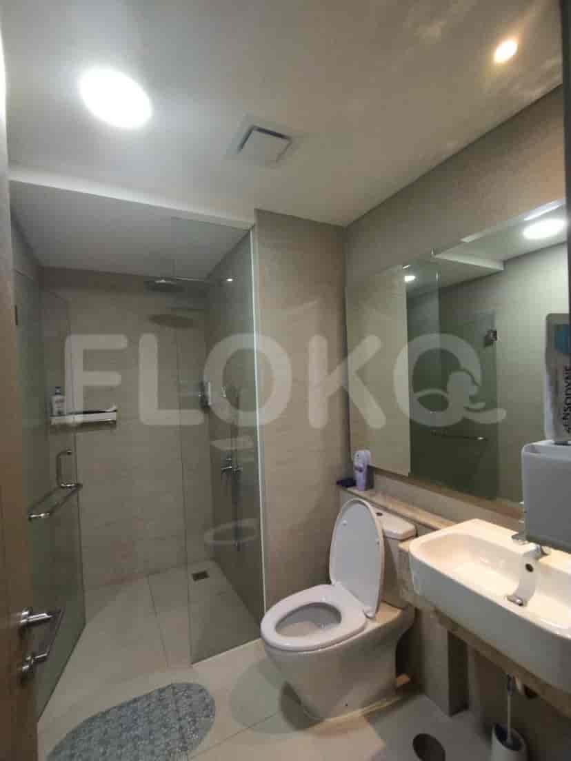 Bathroom with a glass shower, a toilet, and a sink.