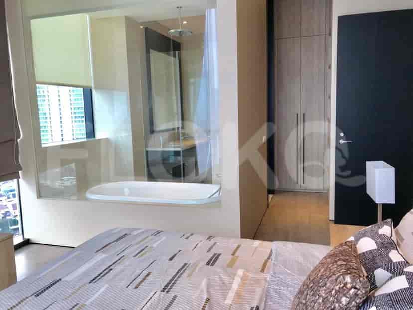 Luxurious bathroom with a bathtub, rain shower, and modern design.