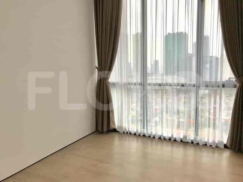 Spacious room with large windows and a cityscape view.