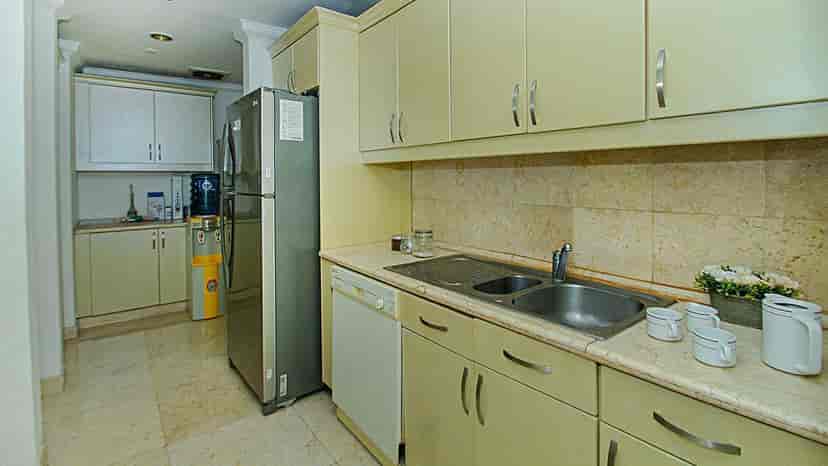 A kitchen with cabinets and appliances.