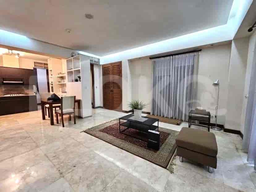 A spacious living room with a dining area and an open kitchen.