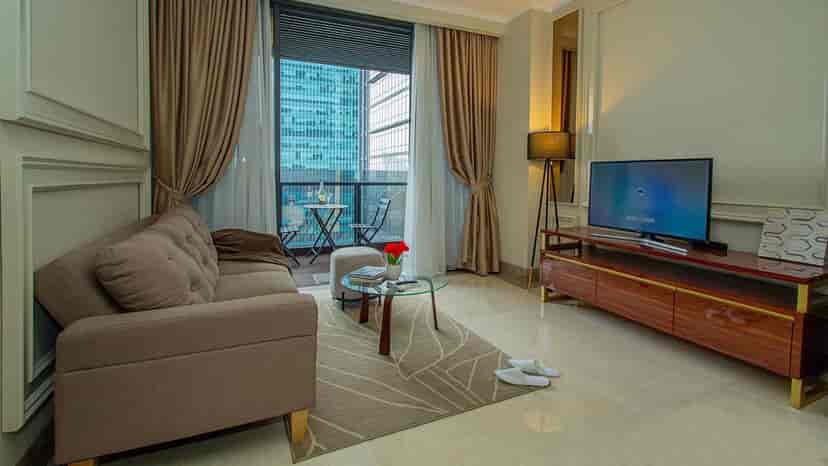 A living room with a sofa, a small table, and a view.