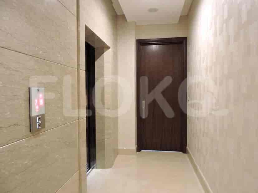 A hallway with an elevator door and a wooden door.