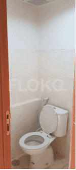 A small bathroom with a toilet, and the door open.