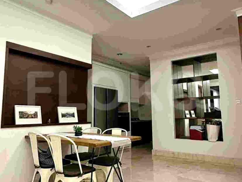 Dining area with a wooden table and chairs, adjacent to the kitchen.