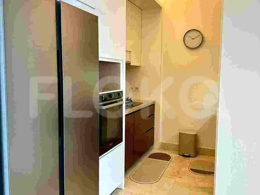 Compact kitchen with a refrigerator, oven, stovetop, and cabinets.