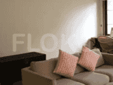 A section of the living room showing a sofa with cushions.