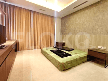 Bedroom with a mattress on the floor, bedside tables, and curtains.