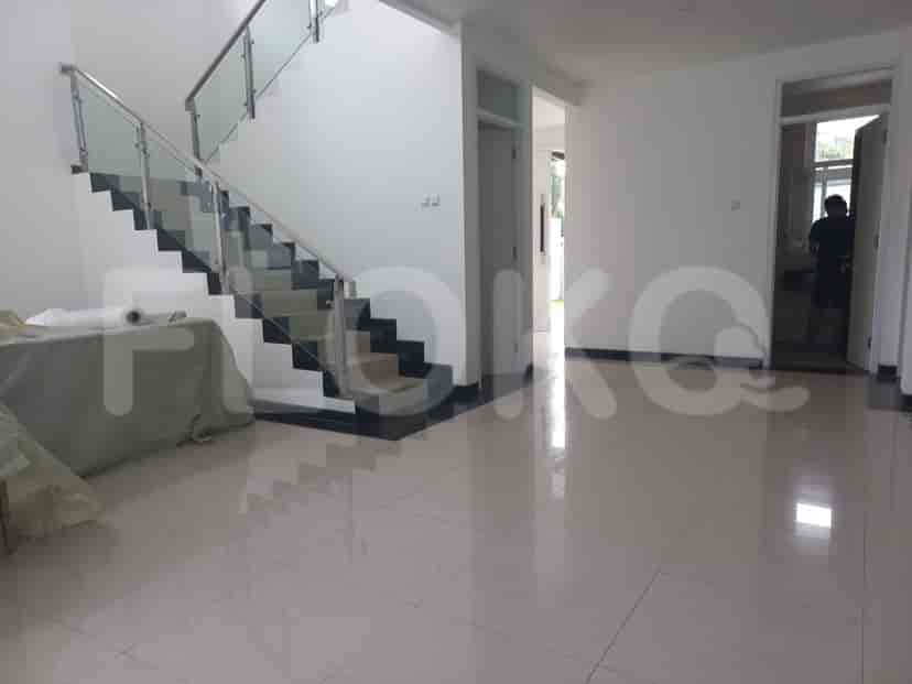 A staircase with glass railings and tiled steps, leading to the upper floor.
