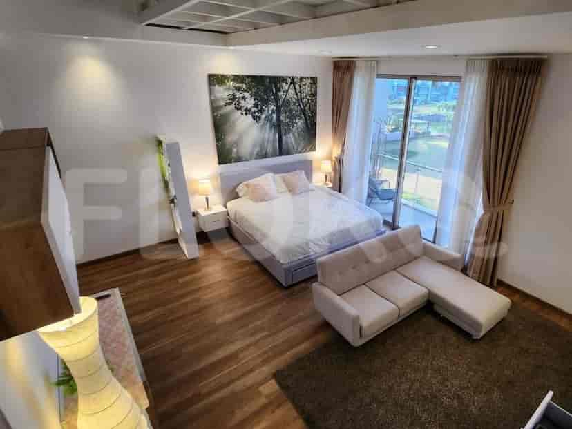 A modern bedroom with a large bed, a sofa, and a large artwork.
