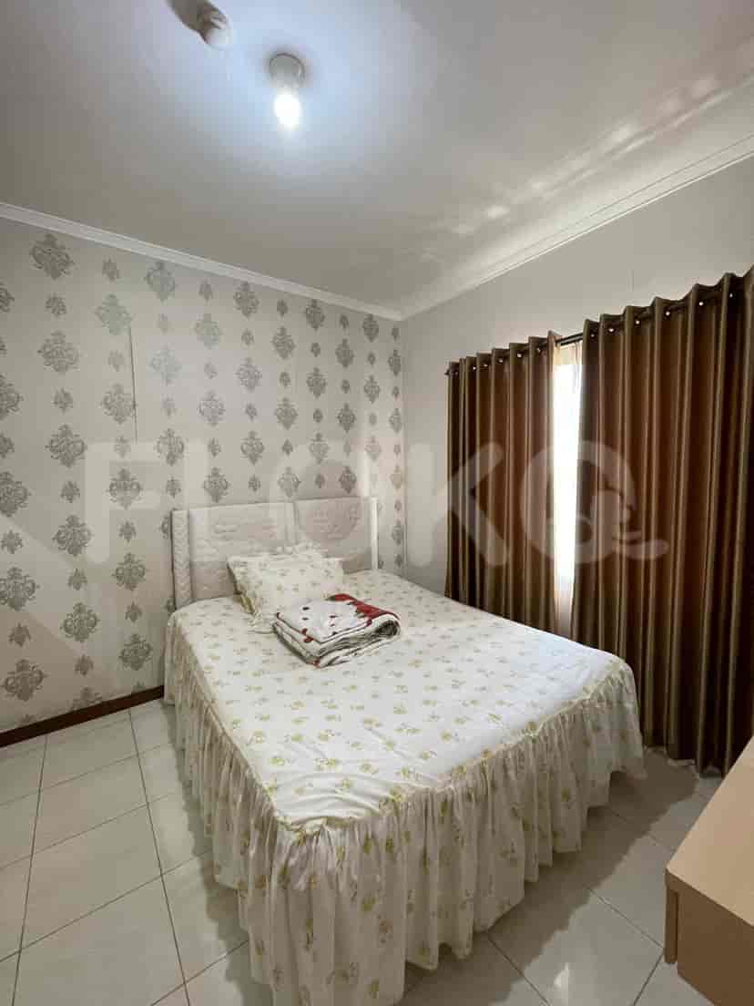 Bedroom with bed, curtains and wallpaper.