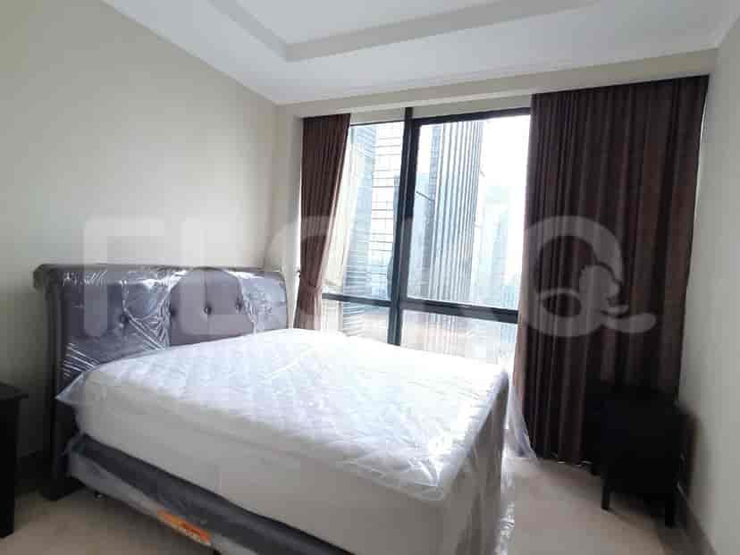 Another bedroom with a bed and large windows.