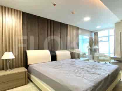 Master bedroom with a king-sized bed and wooden paneling.