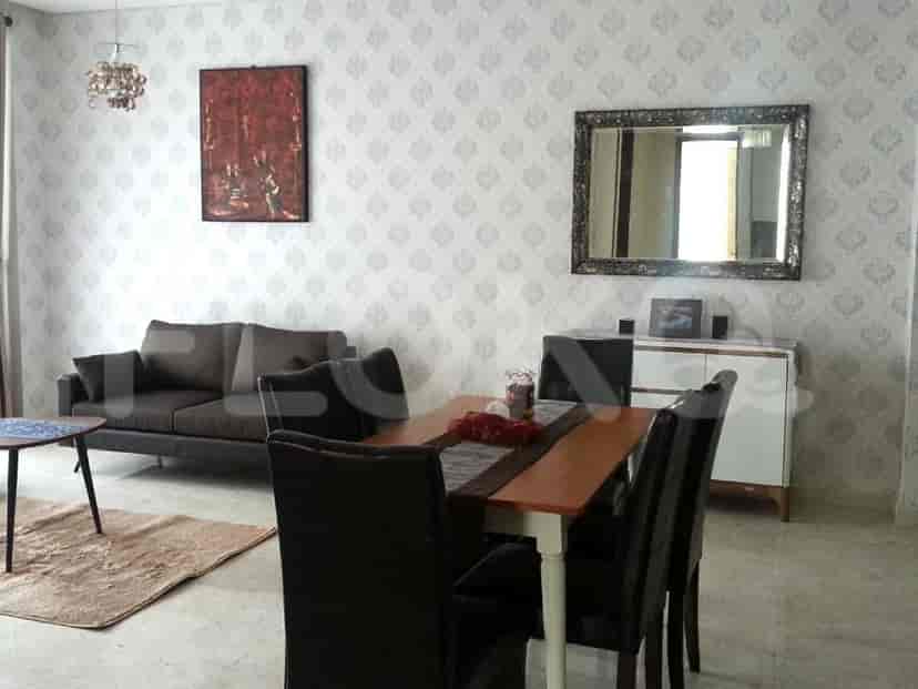 Elegant living space featuring a dining table, sofa, and decorative elements.