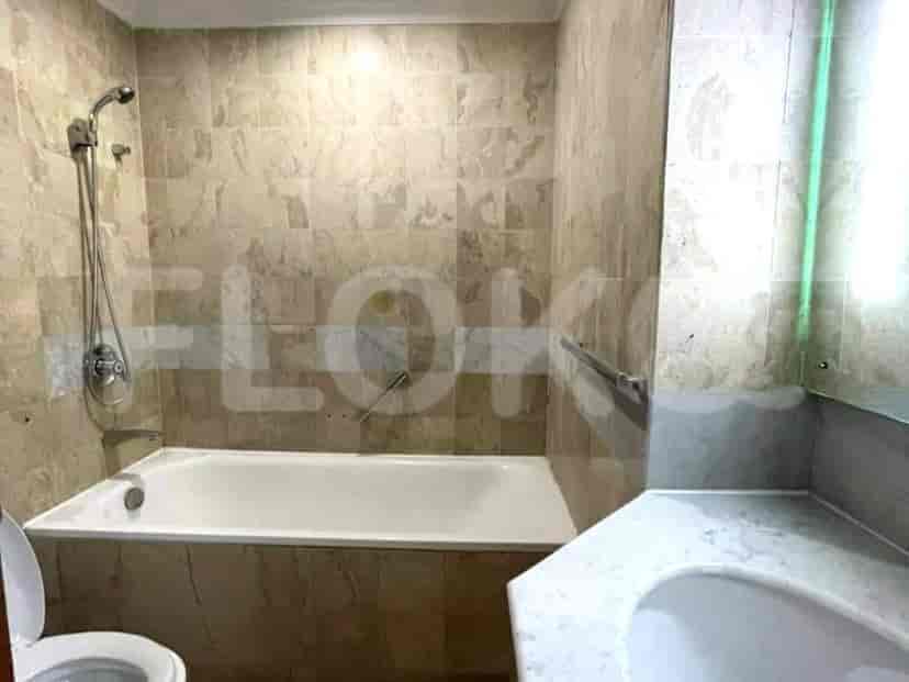 A bathroom with a bathtub, tiled walls, and a shower.