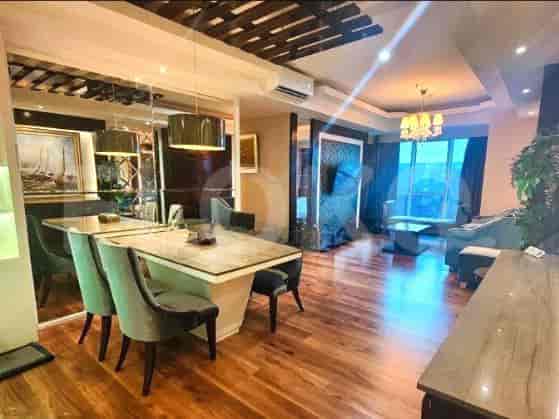 Combined dining and living areas with a large dining table and sofa.
