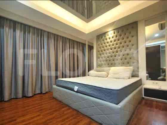 A bedroom with a large bed and modern design.