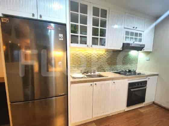 A modern kitchen with stainless steel appliances and white cabinetry.